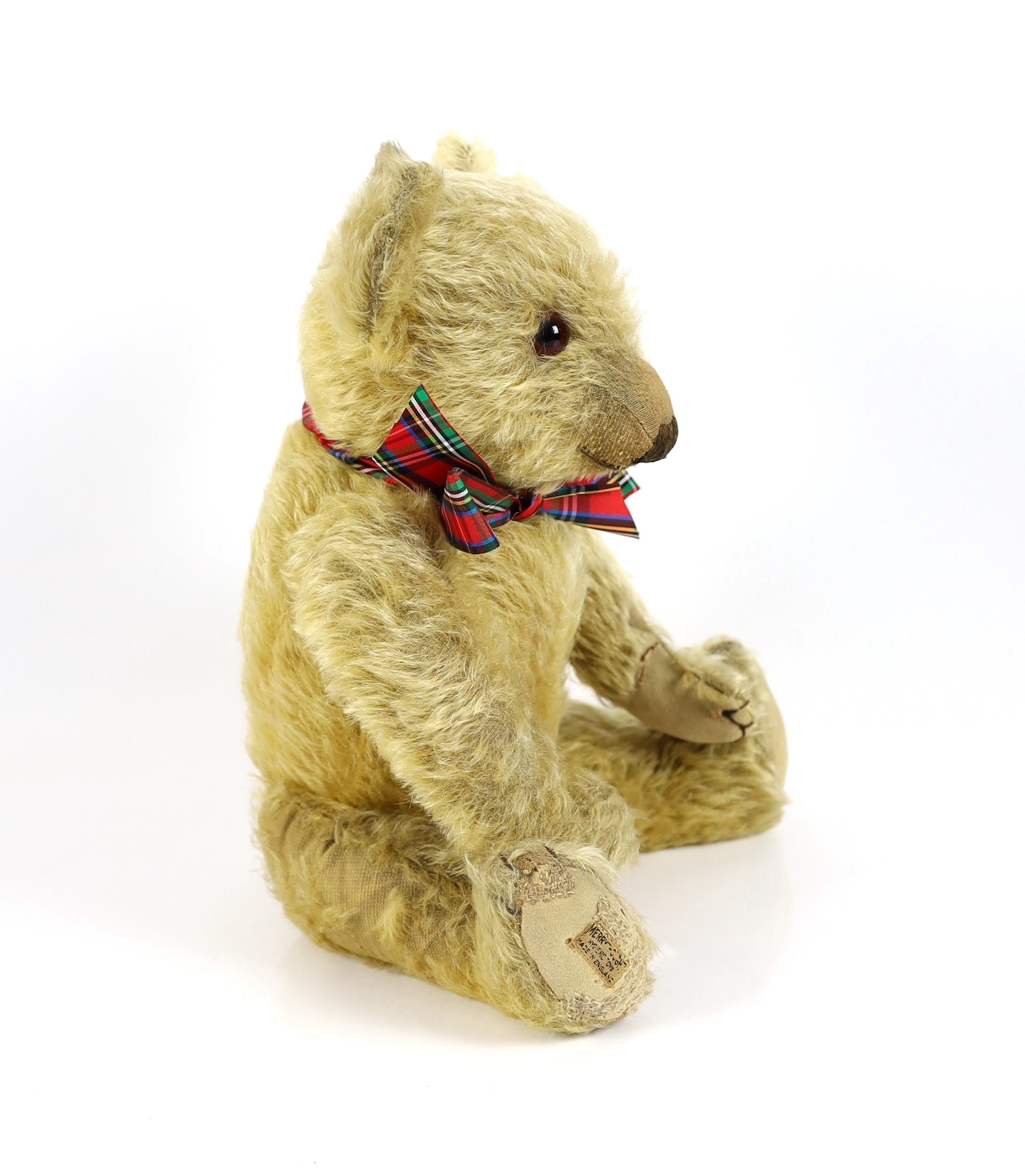 A 1930's Merrythought bear, with label, 44cm, old repair to foot, some hair loss